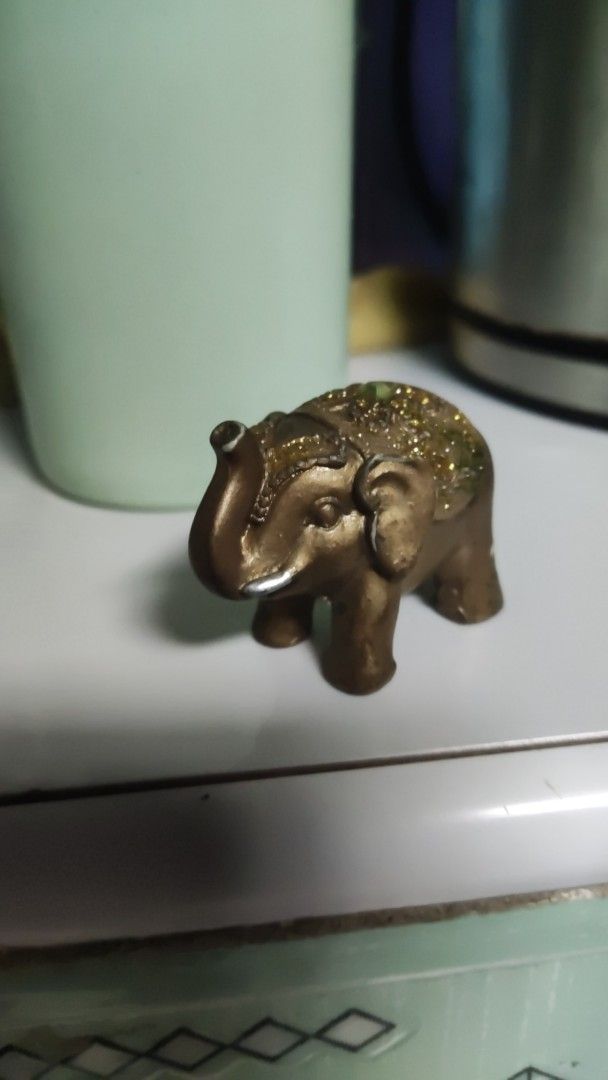 Decorative Bronze Elephant Figurine with Glitter Accent (Category: Other Home Decor) located in Manila. Submitted by ruane_raleigh12 (Listing ID 1444684200, Image 2). Description: - Adorable little elephant figurine - Bronze color with sparkling glitter details on back and head - Compact and small size, ideal for display - Perfect for shelves, desks, or as a decorative accent - A charming addition for collectors or as a small gift mabigat siya.
