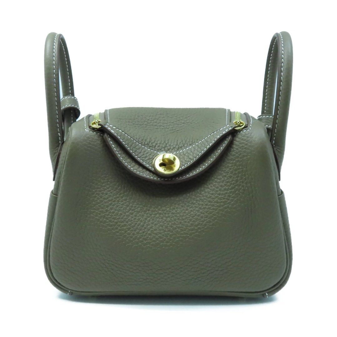 Designer Style Leather Handbag (Category: Luxury Bags & Wallets) located in Pasig City. Submitted by mvsdb (Listing ID 1444695627, Image 1). Description: - Grey pebbled leather handbag - Top handles and detachable shoulder strap - Elegant gold hardware details - Secure zip closure for the main compartment - Convenient small flap pocket on the front - Protective plastic still on some hardware - Ideal for everyday use.