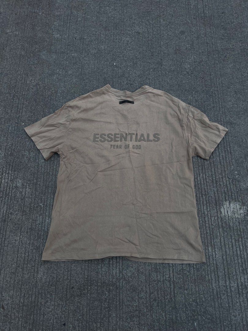 Fear of God Essentials T-Shirt Size M (Category: Tshirts & Polo Shirts ) located in Quezon City. Submitted by .next_wear (Listing ID 1444710696, Image 1). Description: - Brand: Fear of God Essentials - Color: Brown - Size: Medium (M) - Material: 100% Cotton - Features: Iconic Essentials logo printed on the back - Style: Casual wear, everyday essential.