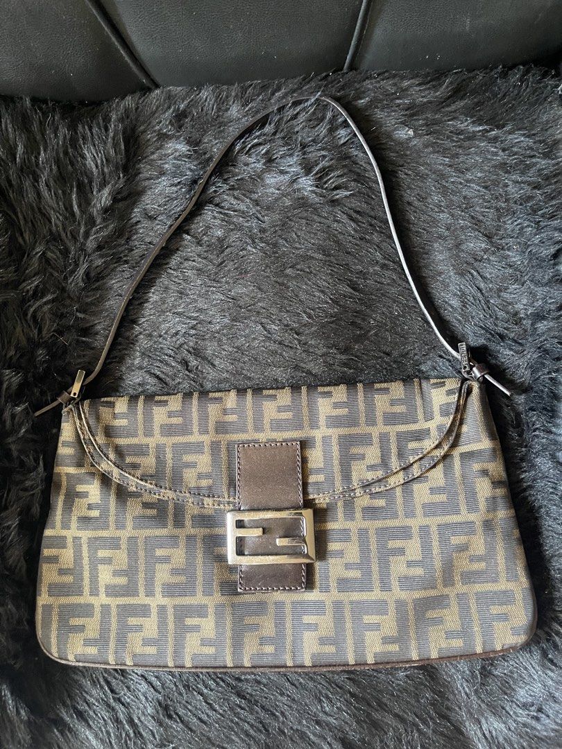 Fendi Zucca Double Flap Canvas Baguette Bag (Category: Luxury Bags & Wallets) located in Davao. Submitted by boodle4lyf (Listing ID 1444768496, Image 1). Description: Authentic or moneyback Fendi Baguette bag with iconic Zucca print. Brown/beige canvas with leather trim and silver buckle. Single shoulder strap. Has signs of wear in the corners but can be retouched as no major damages such as open pipings. Buckle has scratches as well..
