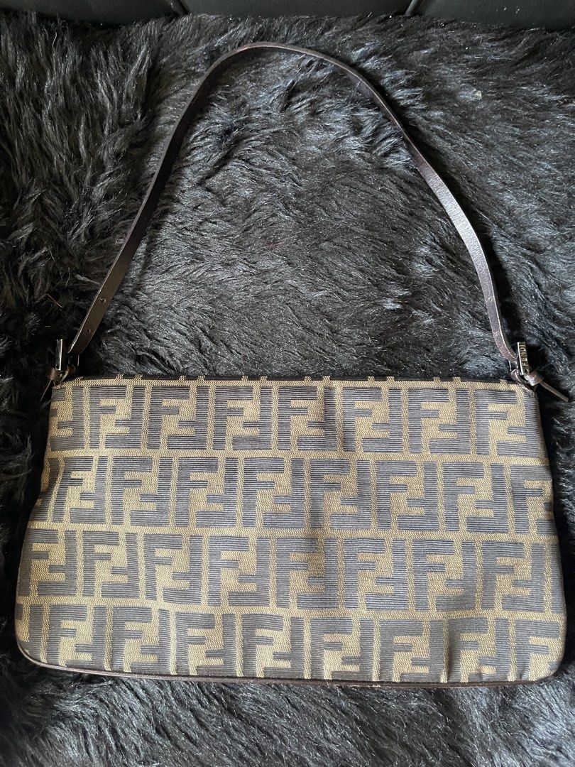 Fendi Zucca Double Flap Canvas Baguette Bag (Category: Luxury Bags & Wallets) located in Davao. Submitted by boodle4lyf (Listing ID 1444768496, Image 2). Description: Authentic or moneyback Fendi Baguette bag with iconic Zucca print. Brown/beige canvas with leather trim and silver buckle. Single shoulder strap. Has signs of wear in the corners but can be retouched as no major damages such as open pipings. Buckle has scratches as well..
