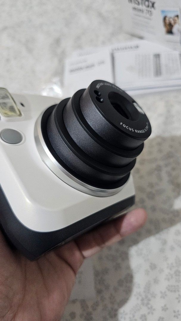Fujifilm Instax Mini 70 Instant Camera (Category: Cameras) located in Manila. Submitted by dironche8469248 (Listing ID 1444815399, Image 1). Description: - White & Grey Fujifilm Instax Mini 70 - Comes with original box and paperwork - Used but not Abused - 60mm lens - Focus range: 0.3m to infinity - Ideal for instant photo memories - Ready for your next adventure! - Negotiable RFS- need funds.