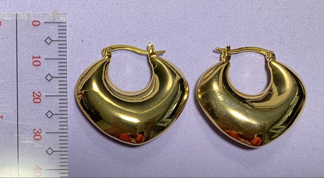 Gold Heart Hoop Earrings (Category: Earrings) located in Mabalacat. Submitted by somethingoldsomethingnew28 (Listing ID 1444747436, Image 1). Description: - Chunky gold heart-shaped hoop earrings - Nice shine and substantial feel - Versatile for everyday wear or dressing up - Secure closure mechanism - Approximately 3.5cm in length.