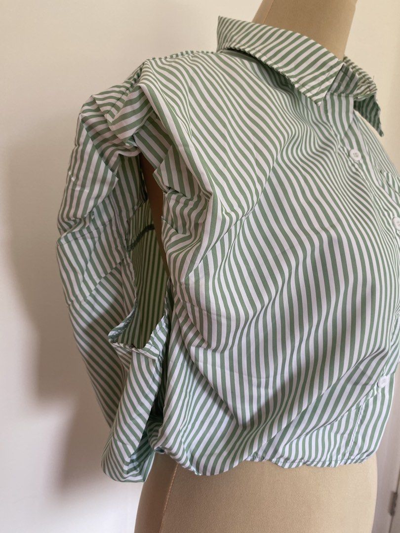 Green and White Striped Cropped Button-Up Shirt (Category: Shirts) located in Santa Rosa. Submitted by summerbrunch (Listing ID 1444856259, Image 3). Description: BUY WORTH 1K, GET FREE SHIPPING! EXCEPT FOR STROLLER BAG MANNEQUIN SIZE: Medium Has garterize back Never worn - Cute green and white striped cropped shirt - Button-up front with a collar - Short cap sleeves with gathered detail - Elasticated hem - Pairs well with high-waisted bottoms - 