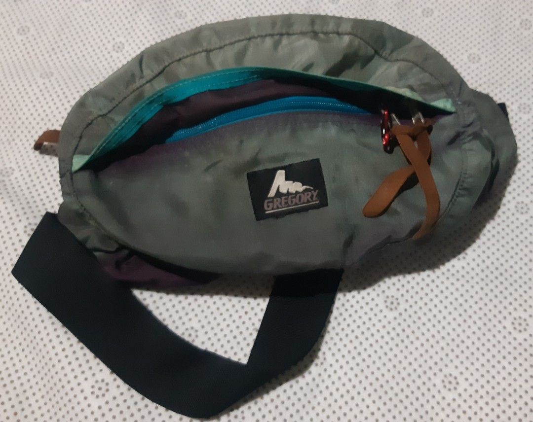 Gregory Waist Bag Fanny Pack (Category: Belt bags, Clutches and Pouches) located in Malaybalay. Submitted by rielstuff (Listing ID 1444811152, Image 2). Description: Gregory waist bag in a muted green color. Has multiple compartments for storage. The back has padded mesh for comfort. Adjustable strap with buckle closure. Great for travel or everyday use. Shows some signs of wear but still functional..