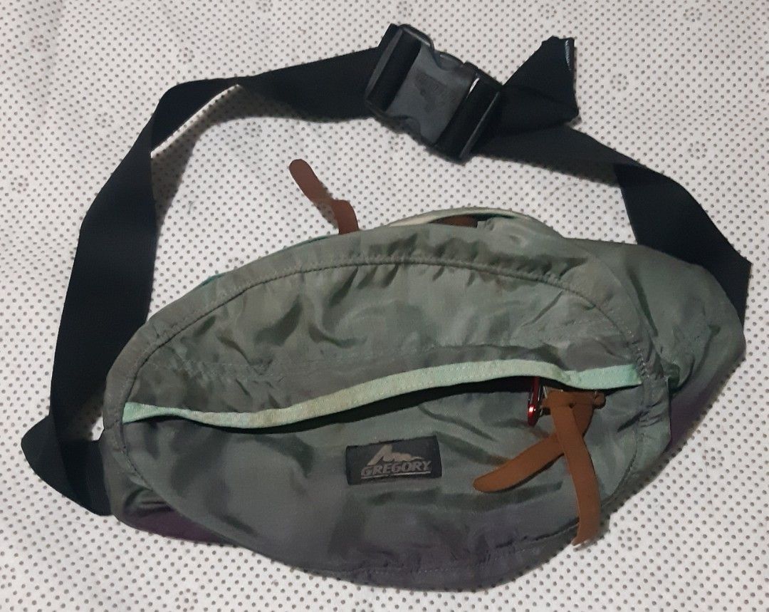 Gregory Waist Bag Fanny Pack (Category: Belt bags, Clutches and Pouches) located in Malaybalay. Submitted by rielstuff (Listing ID 1444811152, Image 1). Description: Gregory waist bag in a muted green color. Has multiple compartments for storage. The back has padded mesh for comfort. Adjustable strap with buckle closure. Great for travel or everyday use. Shows some signs of wear but still functional..