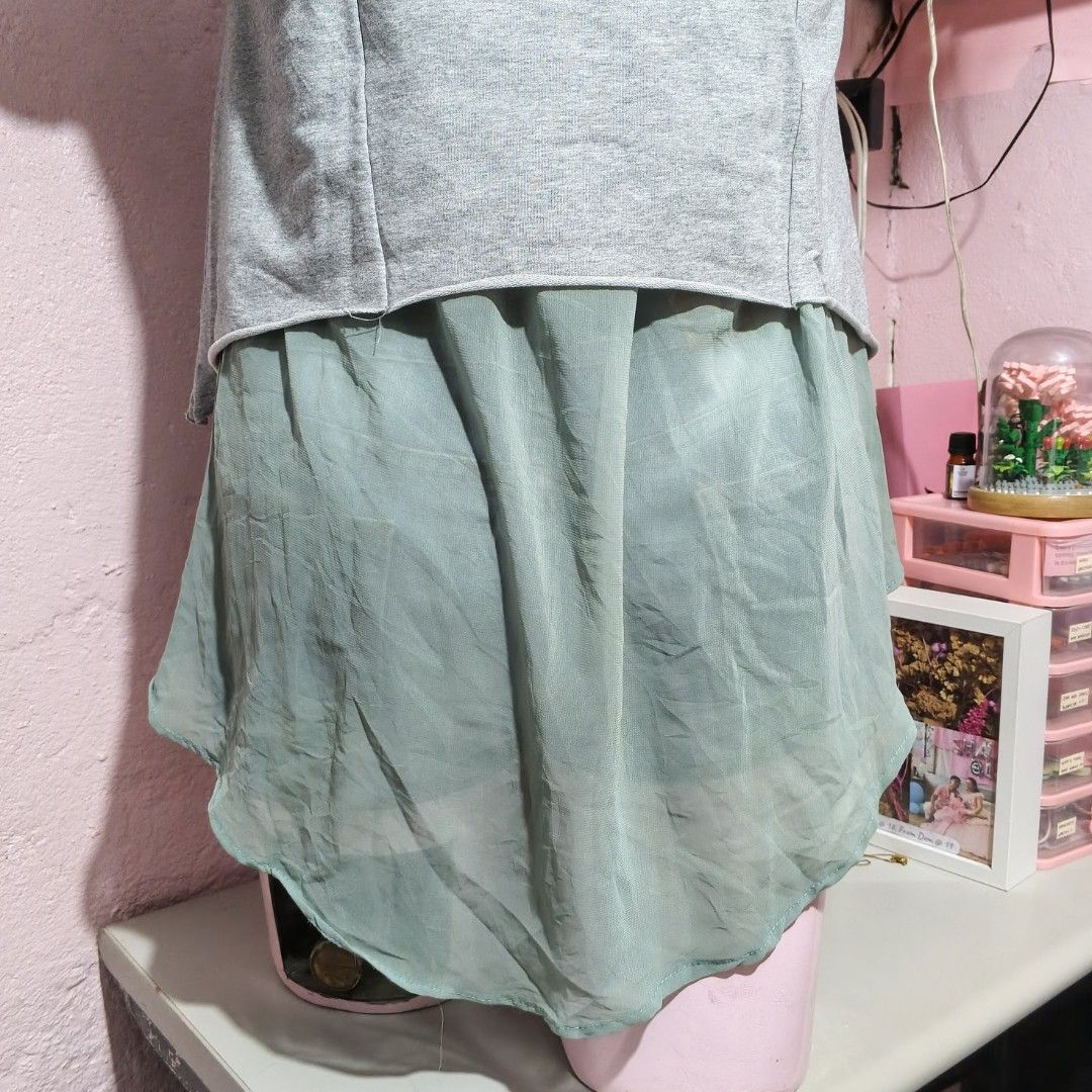 Grey T-shirt with Light Green Collar and Undershirt (Category: Shirts) located in Quezon City. Submitted by ysaai (Listing ID 1444688296, Image 2). Description: - Grey t-shirt with light green collar - Large Chanel logo and text on front - Layered look with light green undershirt detail - Short sleeves with raw hem finish - Ideal for casual and stylish wear ‎📍 Location: Quezon City ‎🧾 MOP: Gcash / Maya / GoTyme / Maribank ‎🛵 MOD: J&T / Lalamov