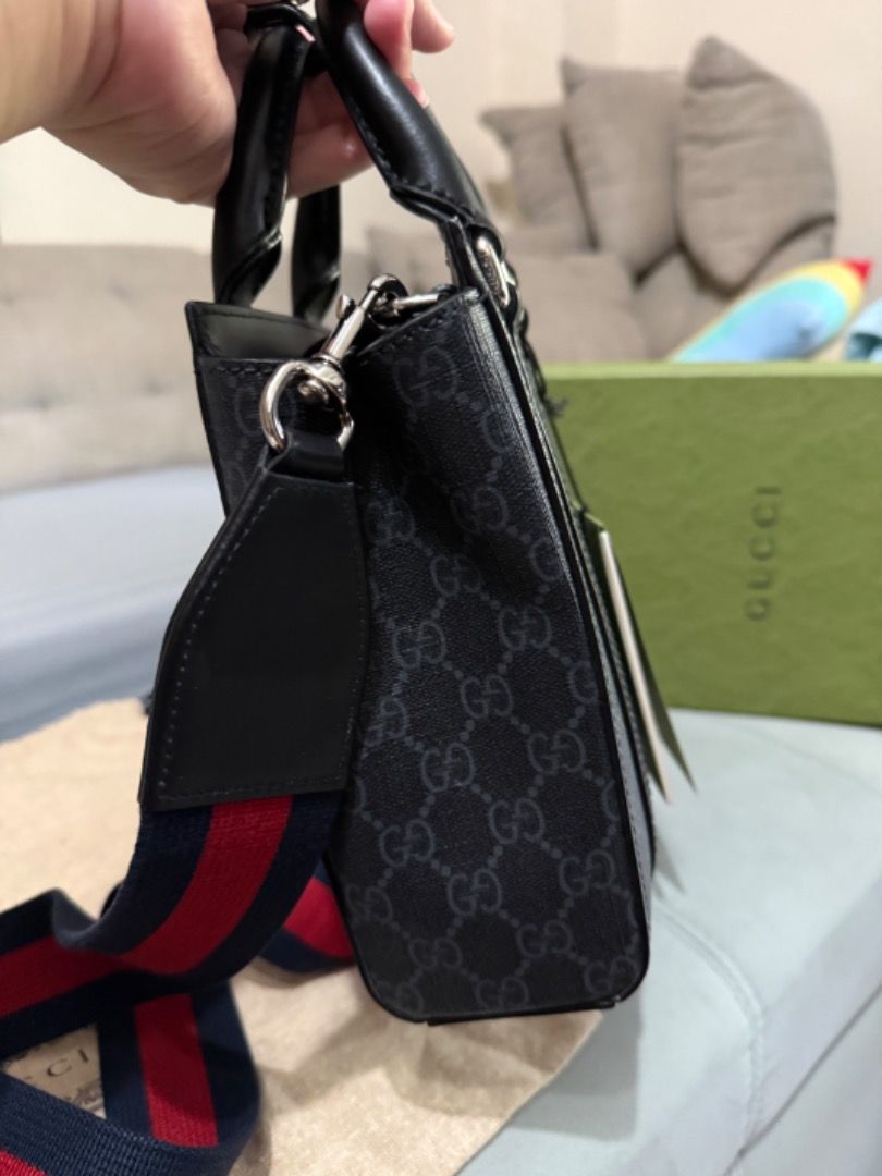 Gucci Ophidia GG Mini Tote Bag (Category: Luxury Bags & Wallets) located in Quezon City. Submitted by directrlmartinez (Listing ID 1444694178, Image 3). Description: - Authentic Gucci mini tote bag - Classic black GG monogram pattern - Top handles - Detachable strap with red and blue stripes - Made in Italy - Includes original dust bag and tags.