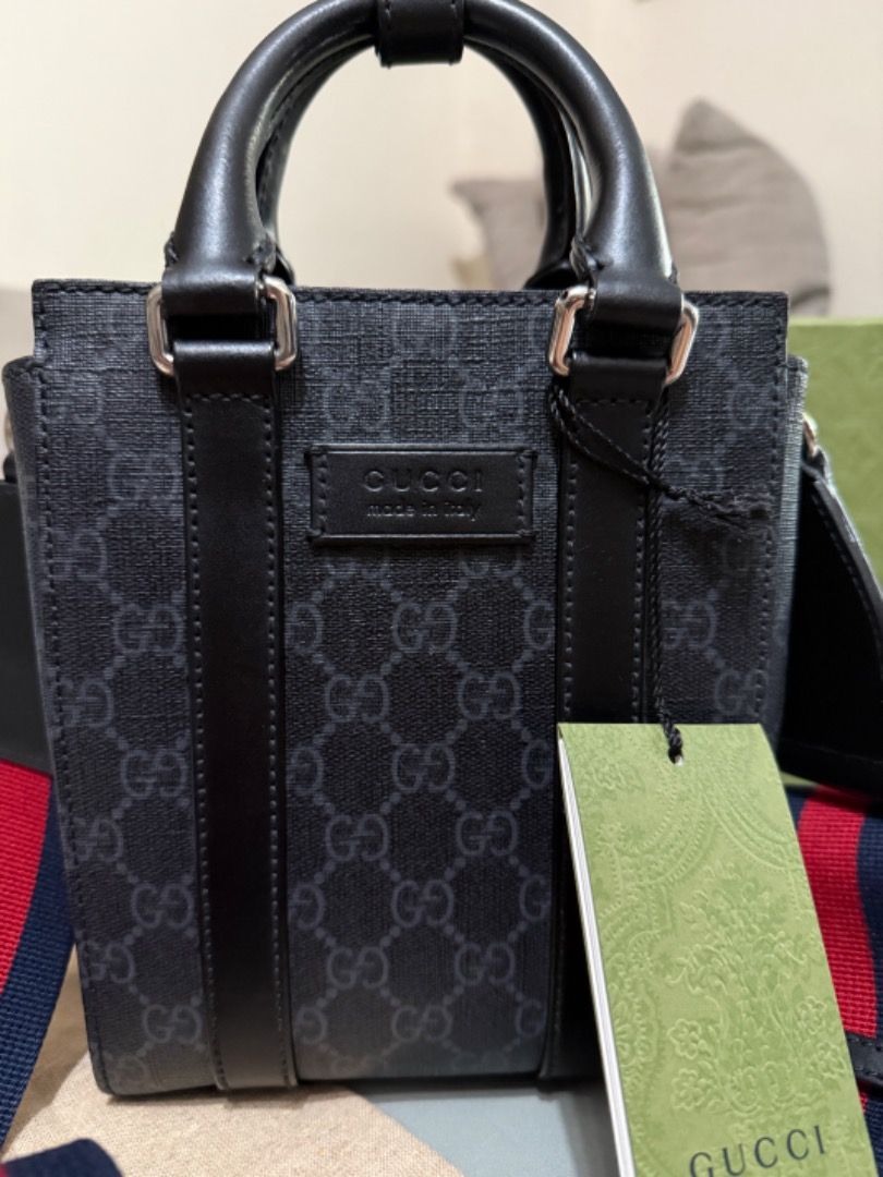 Gucci Ophidia GG Mini Tote Bag (Category: Luxury Bags & Wallets) located in Quezon City. Submitted by directrlmartinez (Listing ID 1444694178, Image 2). Description: - Authentic Gucci mini tote bag - Classic black GG monogram pattern - Top handles - Detachable strap with red and blue stripes - Made in Italy - Includes original dust bag and tags.