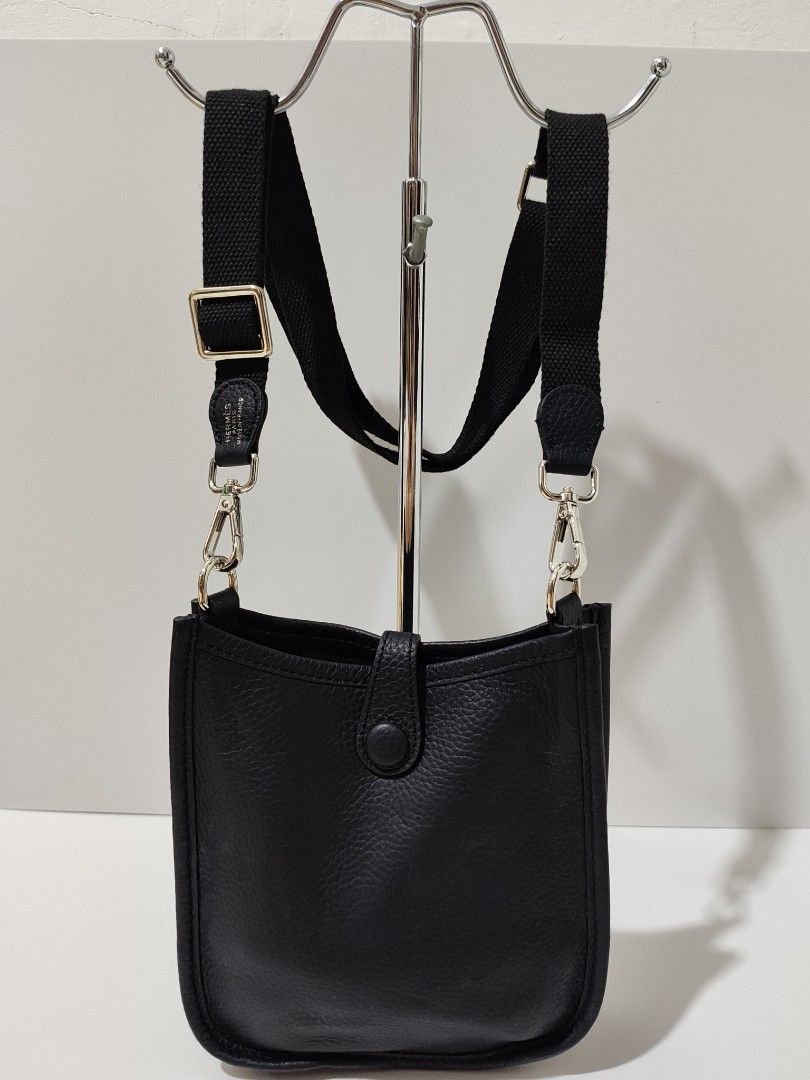Hermes Black Leather Crossbody Bag (Category: Luxury Bags & Wallets) located in Bulacan. Submitted by abejeroamy80846 (Listing ID 1444733395, Image 2). Description: - Black leather crossbody bag - Iconic H cutout detail - Adjustable canvas strap - Silver hardware - Secure snap closure - Unlined interior - Ideal for everyday use - Approximate dimensions: 7" (height) x 5" (width).