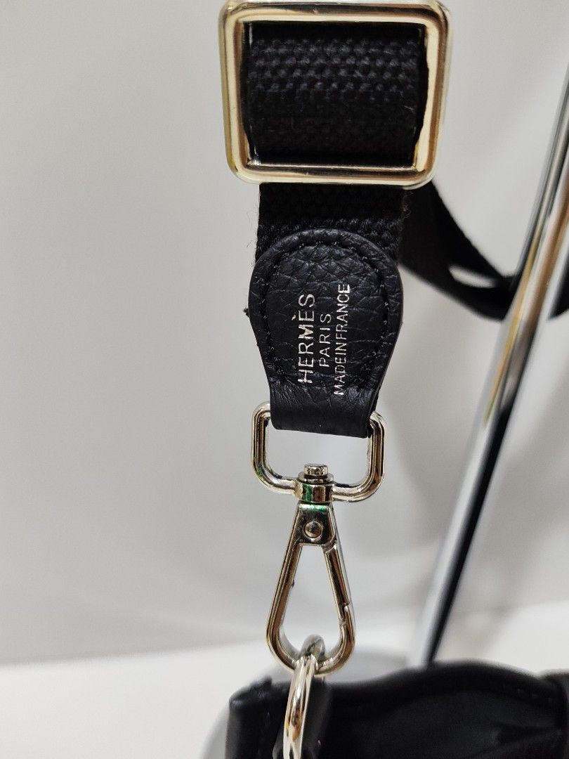 Hermes Black Leather Crossbody Bag (Category: Luxury Bags & Wallets) located in Bulacan. Submitted by abejeroamy80846 (Listing ID 1444733395, Image 3). Description: - Black leather crossbody bag - Iconic H cutout detail - Adjustable canvas strap - Silver hardware - Secure snap closure - Unlined interior - Ideal for everyday use - Approximate dimensions: 7" (height) x 5" (width).