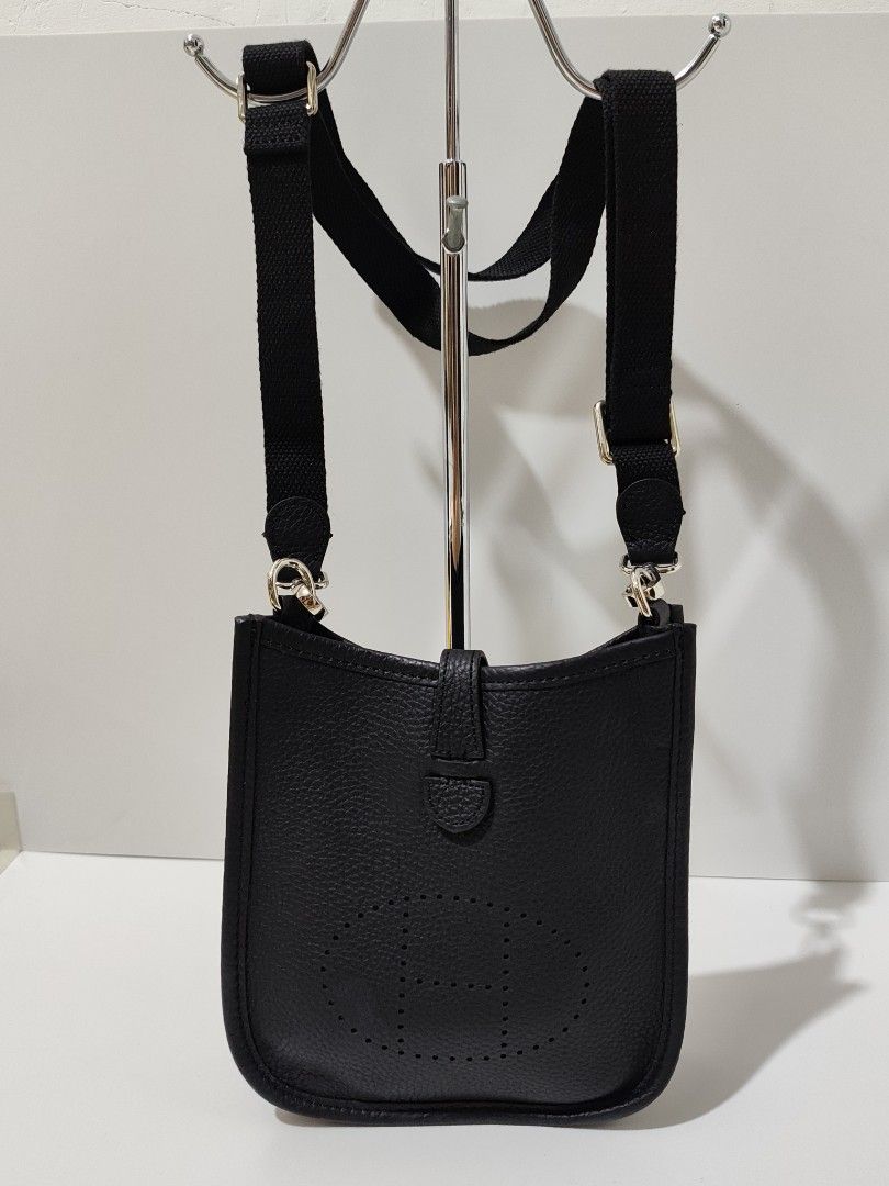 Hermes Black Leather Crossbody Bag (Category: Luxury Bags & Wallets) located in Bulacan. Submitted by abejeroamy80846 (Listing ID 1444733395, Image 1). Description: - Black leather crossbody bag - Iconic H cutout detail - Adjustable canvas strap - Silver hardware - Secure snap closure - Unlined interior - Ideal for everyday use - Approximate dimensions: 7" (height) x 5" (width).