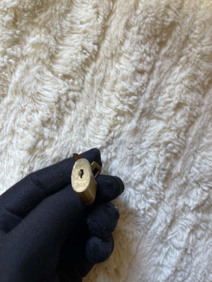 Louis Vuitton Lock and Keys (Category: Other Accessories) located in Naawan. Submitted by twilly.apparel2 (Listing ID 1444700298, Image 3). Description: - Louis Vuitton lock and two keys - Gold tone brass material - Small size, approximately 1 inch tall - Features embossed LV logo on the lock - Keys are also branded - Ideal for securing luggage, diaries, or bags with a touch of luxury.