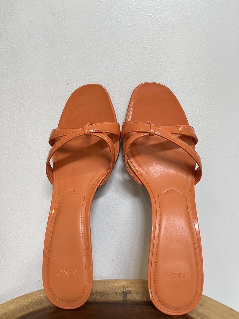 MANGO Orange Square Toe Mule Sandals with Thin Straps Kitten Heel (Category: Heels) located in Muntinlupa City. Submitted by boo_thingthings (Listing ID 1444771455, Image 1). Description: Brand: MANGO • Size: US 7 • Color: Vibrant orange • Features: Glossy patent finish, square toe, strappy design, low kitten heel • Condition: Excellent condition (see photos) – comes with original MANGO box • Style: Chic summer heels perfect for casual or dressed