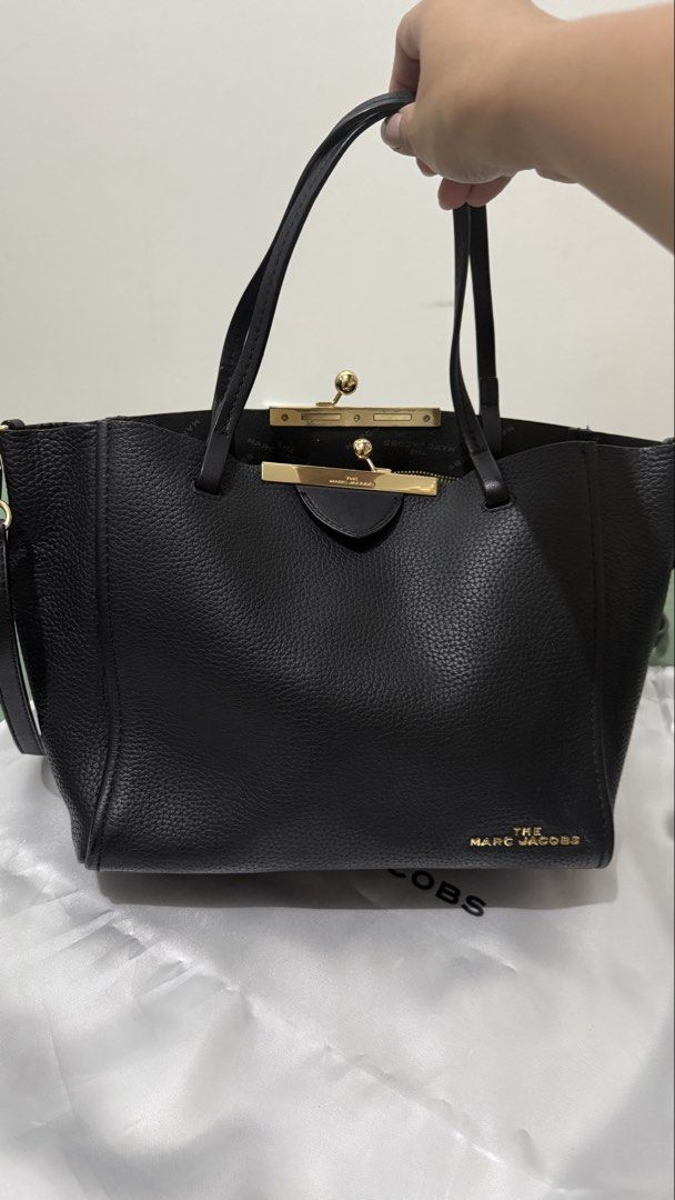 Marc Jacobs Black Leather Tote Bag with Gold Hardware (Category: Luxury Bags & Wallets) located in Cavite. Submitted by magssy (Listing ID 1444729345, Image 1). Description: - Authentic Marc Jacobs black leather tote bag - Unique clasp closure - Comfortable top handles - Detachable shoulder strap for versatility - Elegant gold hardware details - Interior zippered pocket for secure storage - Ideal for everyday wear and stylish outings.