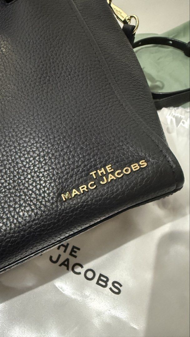 Marc Jacobs Black Leather Tote Bag with Gold Hardware (Category: Luxury Bags & Wallets) located in Cavite. Submitted by magssy (Listing ID 1444729345, Image 3). Description: - Authentic Marc Jacobs black leather tote bag - Unique clasp closure - Comfortable top handles - Detachable shoulder strap for versatility - Elegant gold hardware details - Interior zippered pocket for secure storage - Ideal for everyday wear and stylish outings.