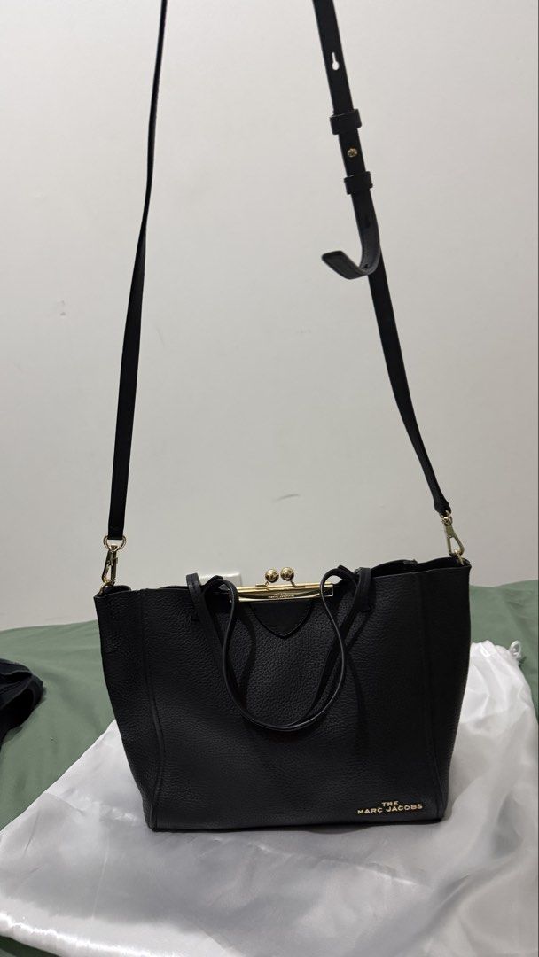 Marc Jacobs Black Leather Tote Bag with Gold Hardware (Category: Luxury Bags & Wallets) located in Cavite. Submitted by magssy (Listing ID 1444729345, Image 2). Description: - Authentic Marc Jacobs black leather tote bag - Unique clasp closure - Comfortable top handles - Detachable shoulder strap for versatility - Elegant gold hardware details - Interior zippered pocket for secure storage - Ideal for everyday wear and stylish outings.