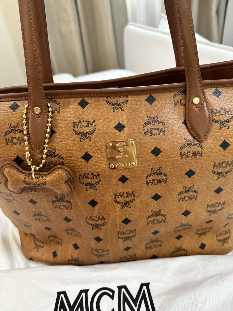 Mcm Cognac Tote Bag (Category: Luxury Bags & Wallets) located in Angeles City. Submitted by lancecamino (Listing ID 1444848104, Image 2). Description: - Authentic MCM Tote Bag - Classic Cognac color with signature logo print - Comes with original dust bag and cute dog tag charm - Perfect for daily essentials and travel - Meetup available in Angeles City, Pampanga.