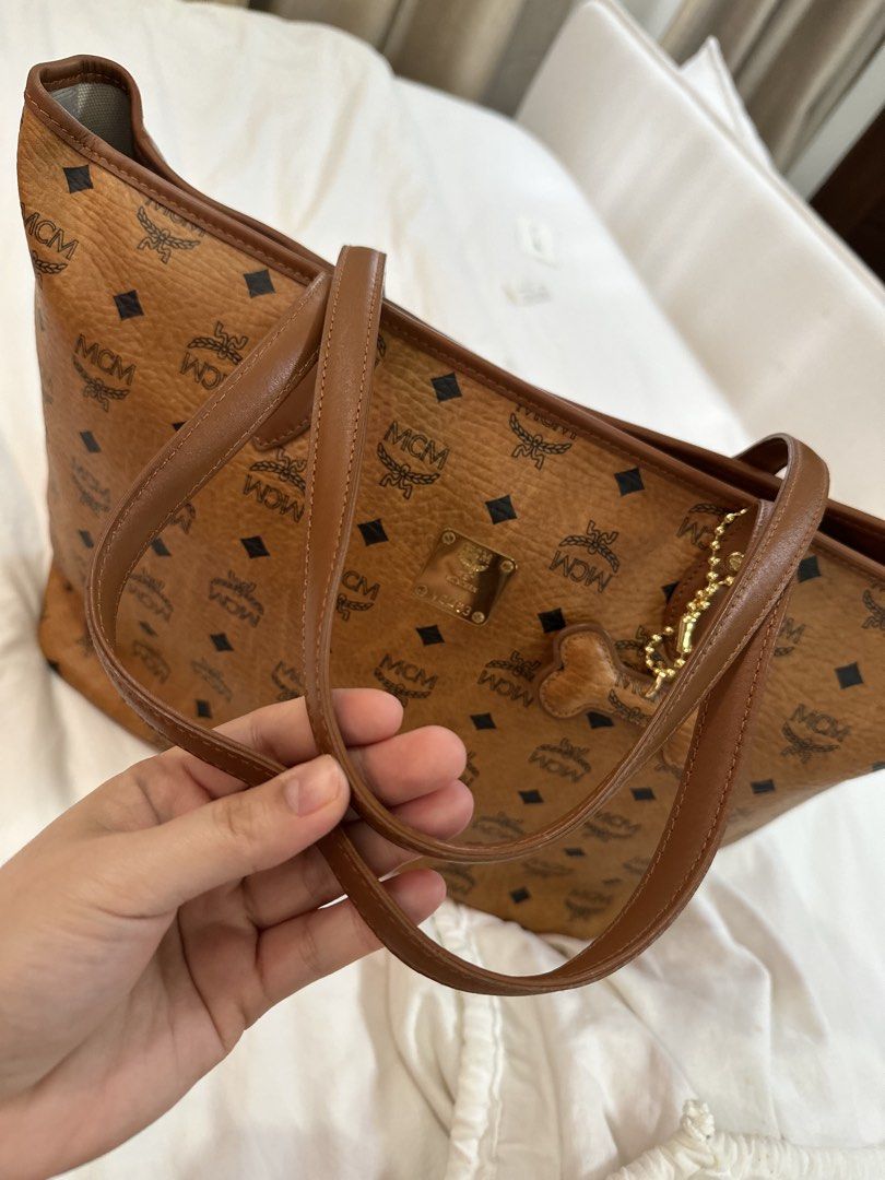 Mcm Cognac Tote Bag (Category: Luxury Bags & Wallets) located in Angeles City. Submitted by lancecamino (Listing ID 1444848104, Image 3). Description: - Authentic MCM Tote Bag - Classic Cognac color with signature logo print - Comes with original dust bag and cute dog tag charm - Perfect for daily essentials and travel - Meetup available in Angeles City, Pampanga.