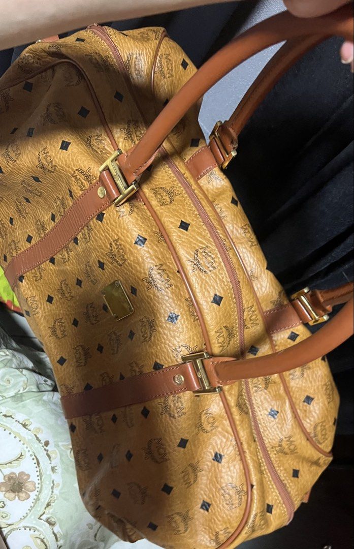 MCM Monogram Duffel Bag (Category: Luxury Bags & Wallets) located in Paranaque City. Submitted by sctmpque (Listing ID 1444775726, Image 1). Description: Made in Germany - Classic MCM duffel bag - All-over monogram print - Genuine leather trim and handles - Elegant gold hardware details - Spacious interior for travel or daily essentials - A timeless and iconic piece.