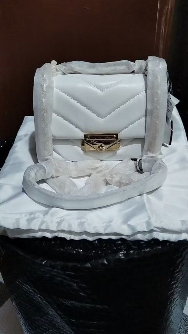 Michael Kors White Quilted Leather Shoulder Bag (Category: Luxury Bags & Wallets) located in Quezon City. Submitted by _rinyang (Listing ID 1444737097, Image 2). Description: - Authentic Michael Kors white quilted leather shoulder bag - Elegant gold hardware - Secure clasp closure - Stylish chain strap - Brand new with tag still attached - Comes with original dust bag and packaging.