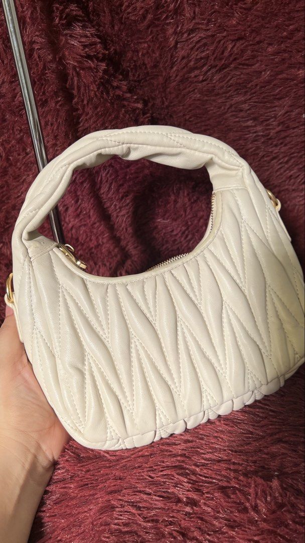 Miu Miu White Quilted Leather Hobo Bag (Category: Luxury Bags & Wallets) located in Muntinlupa City. Submitted by armendaber03743 (Listing ID 1444804913, Image 3). Description: -Miu Miu hobo bag in classic white. - Luxurious quilted leather with elegant gold hardware. - Secure zipper closure for your belongings. - Ideal everyday bag, perfectly sized for essentials..