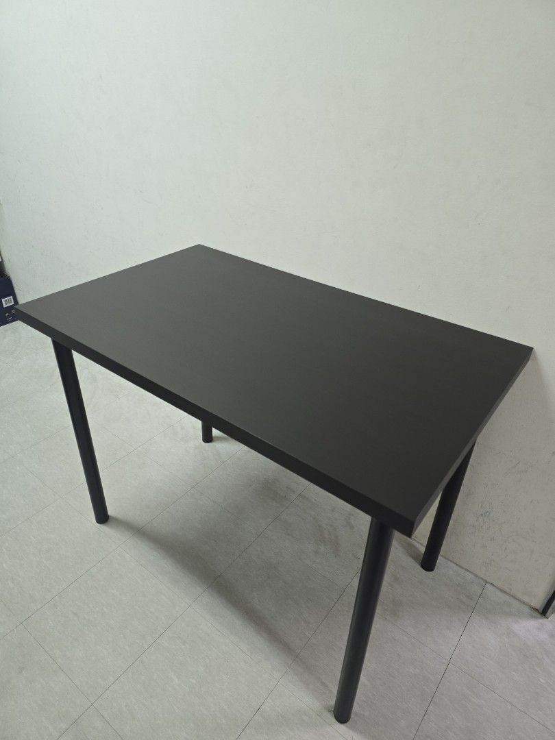 Modern Black Rectangular Table (Category: Tables & Sets) located in Singapore. Submitted by tolin (Listing ID 1444720293, Image 1). Description: - Ikea Table rtp $49.90 - Dimensions 100cm(L)x60cm (W)x73.5cm(H) - Condition as good as new, used with a protective layer - Simple black rectangular table - Sturdy legs for good support - Smooth and flat surface - Perfect as a study desk or small dining table - Easy to clean and maintain - Versatile size