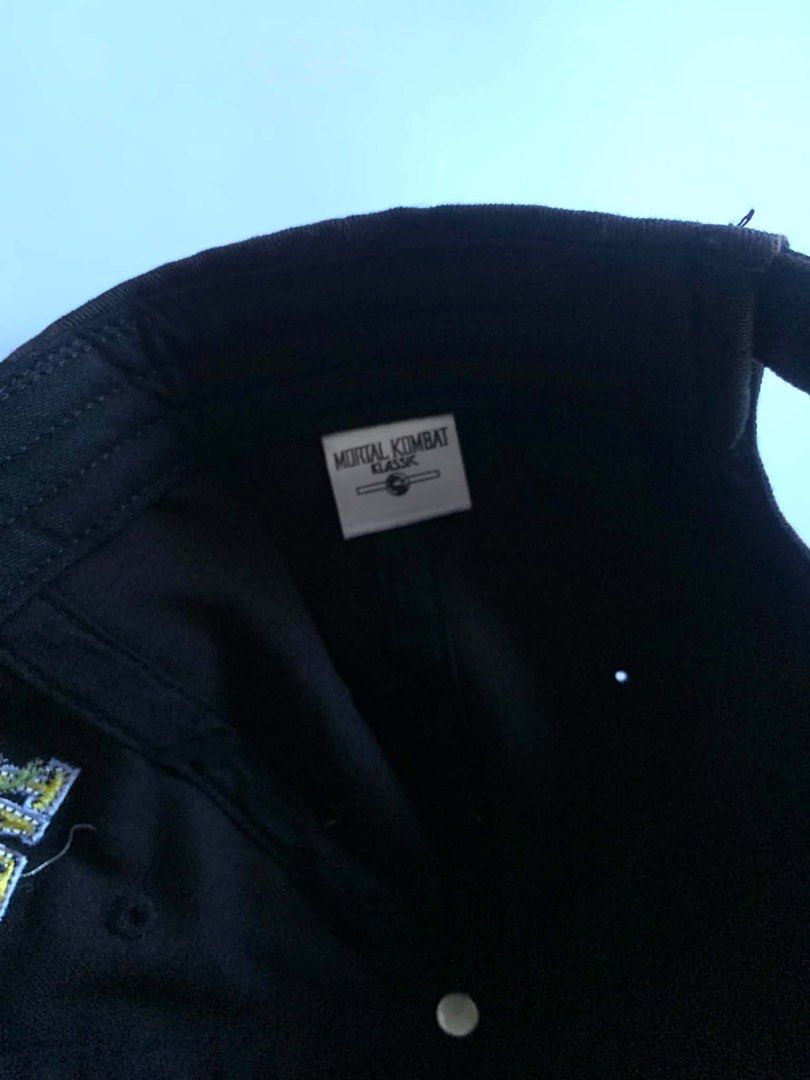 Mortal Kombat Classic "High Punch" Embroidered Baseball Cap (Category: Caps & Hats) located in Caloocan City. Submitted by oddly.yours (Listing ID 1444744326, Image 3). Description: - Black baseball cap - Features embroidered Mortal Kombat Classic logo on the front - 'High Punch' embroidered in red on the side - Tag inside confirms 'Mortal Kombat Classic' - Ideal collectible for Mortal Kombat game enthusiasts.