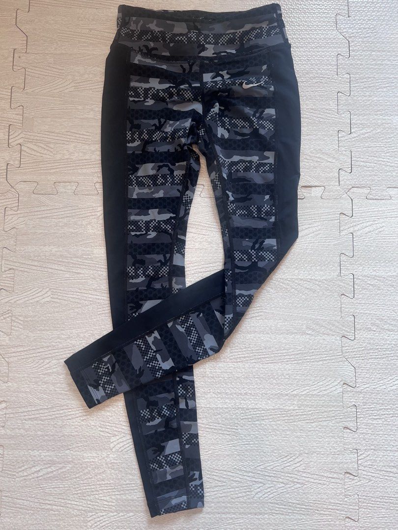 Nike Dri-Fit Camo Leggings (Category: Activewear) located in Makati City. Submitted by nicole_7 (Listing ID 1444754745, Image 1). Description: - Nike Dri-Fit running leggings - Stylish cool grey camouflage and checkerboard pattern - Flattering side panels for a sleek silhouette - Waistband tie - Versatile for workouts or everyday casual wear.