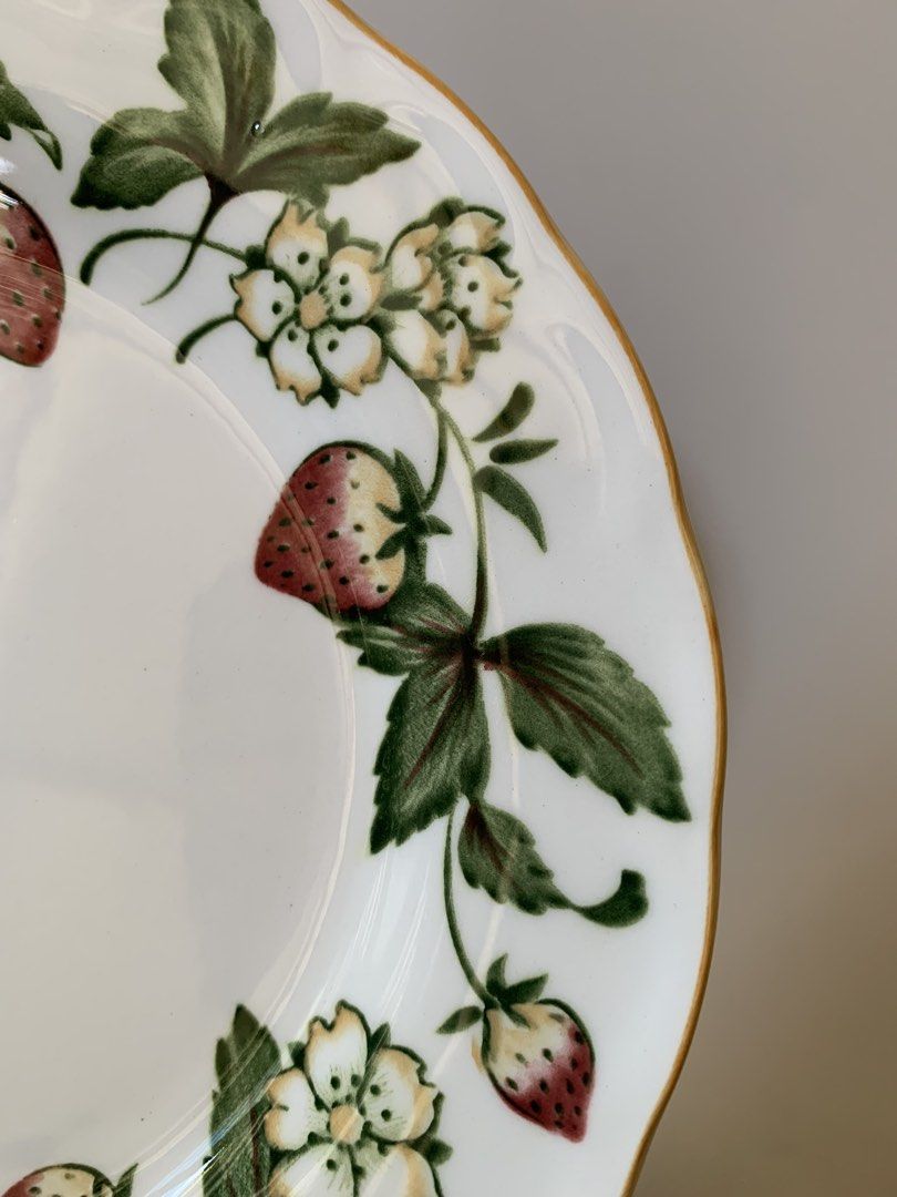 Nikko Spring Valley Casual Living collection Bread Plate (Category: Dinnerware & Cutlery) located in Tandag. Submitted by jeason_22 (Listing ID 1444707849, Image 2). Description: These plates are from the Nikko Spring Valley Casual Living collection, featuring a white porcelain body decorated with a vibrant strawberry and flower vine pattern and a gold-trimmed, scalloped edge. * 7.5 inches in diameter * Brand: Nikko * Pattern: Spring Valley * Mat