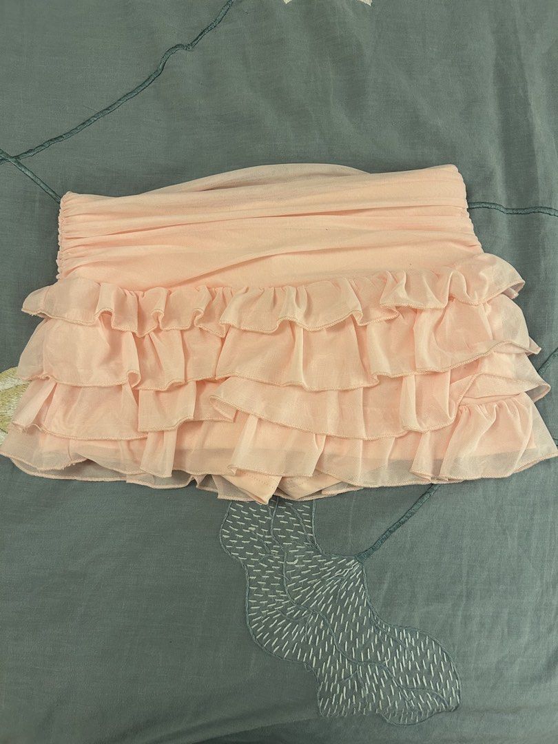 Pink Ruffled Tiered Mini Skirt (Category: Skirts) located in Makati City. Submitted by koalapiuni123 (Listing ID 1444840415, Image 1). Description: - Adorable pink mini skirt - Features a ruffled, tiered design - Ruched detailing on the top section - Ideal for summer outfits or evening wear - Versatile and easy to pair with simple tops.
