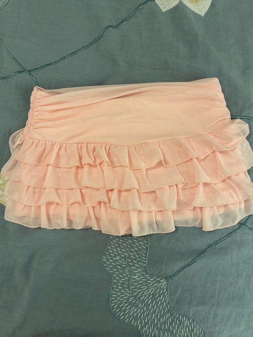 Pink Ruffled Tiered Mini Skirt (Category: Skirts) located in Makati City. Submitted by koalapiuni123 (Listing ID 1444840415, Image 2). Description: - Adorable pink mini skirt - Features a ruffled, tiered design - Ruched detailing on the top section - Ideal for summer outfits or evening wear - Versatile and easy to pair with simple tops.