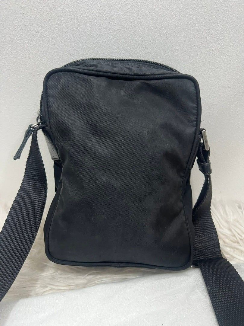 Prada Nylon Crossbody Bag Black (Category: Luxury Bags & Wallets) located in Bayugan. Submitted by daniel2019 (Listing ID 1444812694, Image 2). Description: - Authentic Prada crossbody bag - Black nylon material - Front zip pocket - Main zip compartment - Adjustable strap - Comes with dust bag - Ideal for daily use.