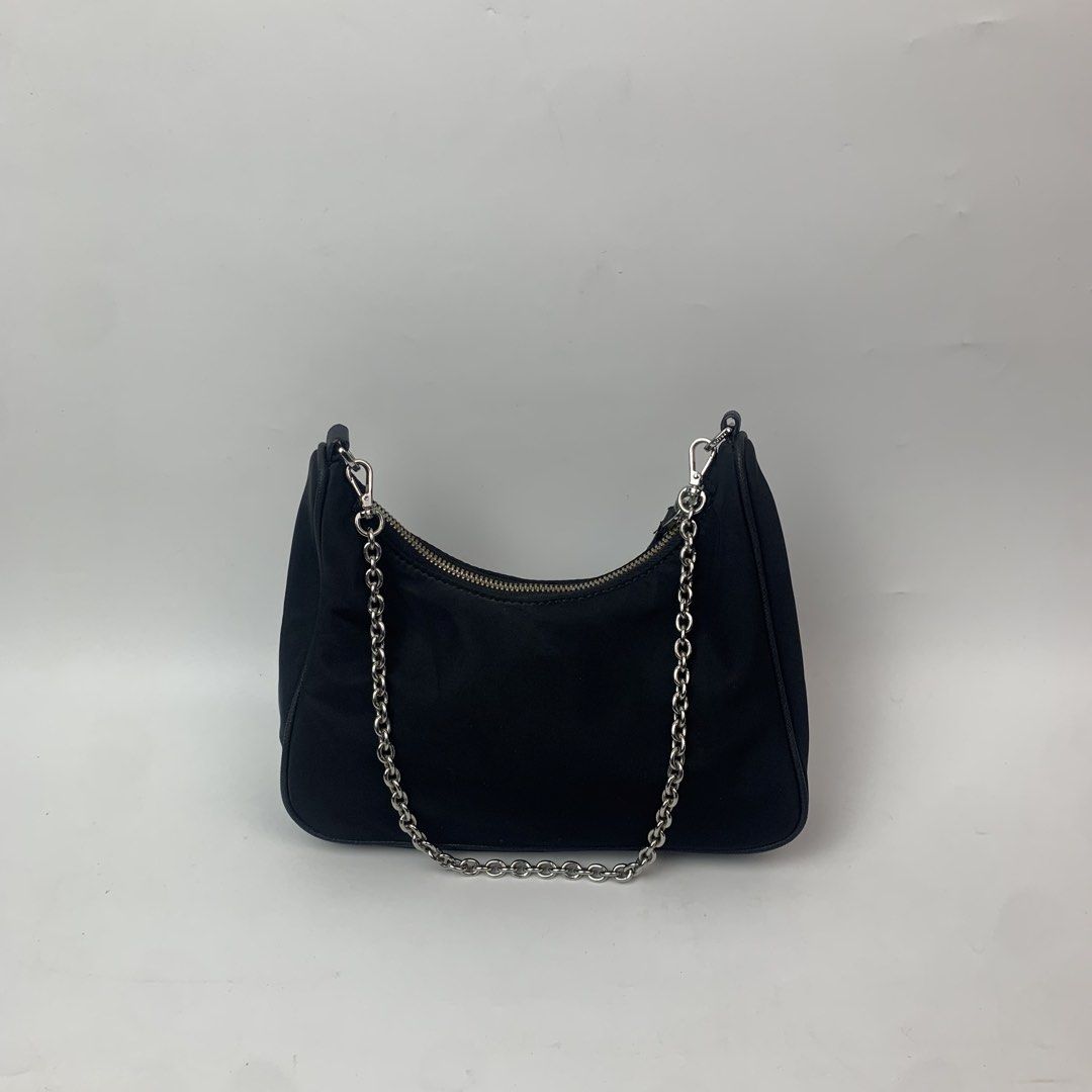 Prada Tessuto Nylon Mini Re-Edition Shoulder Bag Black (Category: Luxury Bags & Wallets) located in Cebu City. Submitted by devourapparel.ph (Listing ID 1444804503, Image 3). Description: WTS! Prada Tessuto Nylon Mini Re-Edition Shoulder Bag Black - Width: 9 inches - Length: 5 inches - Color rate: 9.7/10 - Very good condition - Issue: side seam unraveling ( see last pic ) - Still looks good in the outside Price: 1,800.