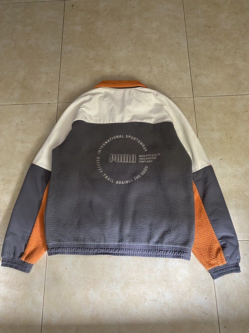 PUMA XTG Trail Woven FZ Jacket (Category: Coats, Jackets and Outerwear) located in Manila. Submitted by grndw.ez (Listing ID 1444811959, Image 2). Description: grey fleece body, orange accents, and a white top panel.