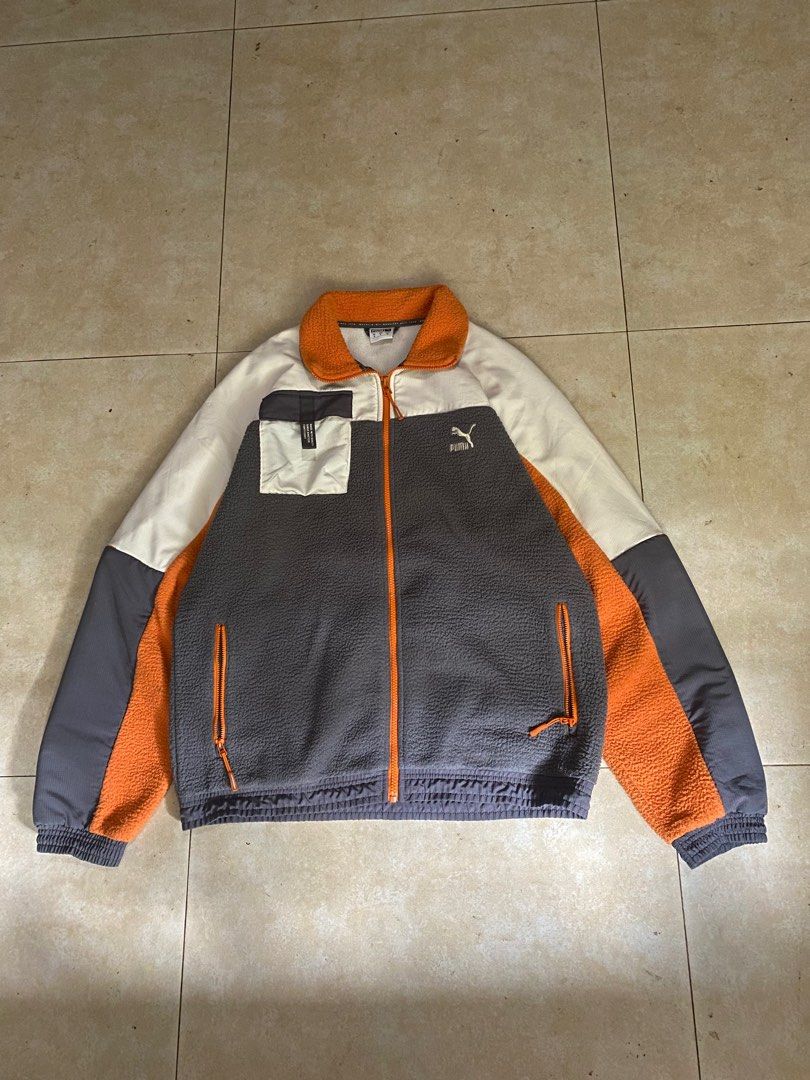 PUMA XTG Trail Woven FZ Jacket (Category: Coats, Jackets and Outerwear) located in Manila. Submitted by grndw.ez (Listing ID 1444811959, Image 1). Description: grey fleece body, orange accents, and a white top panel.