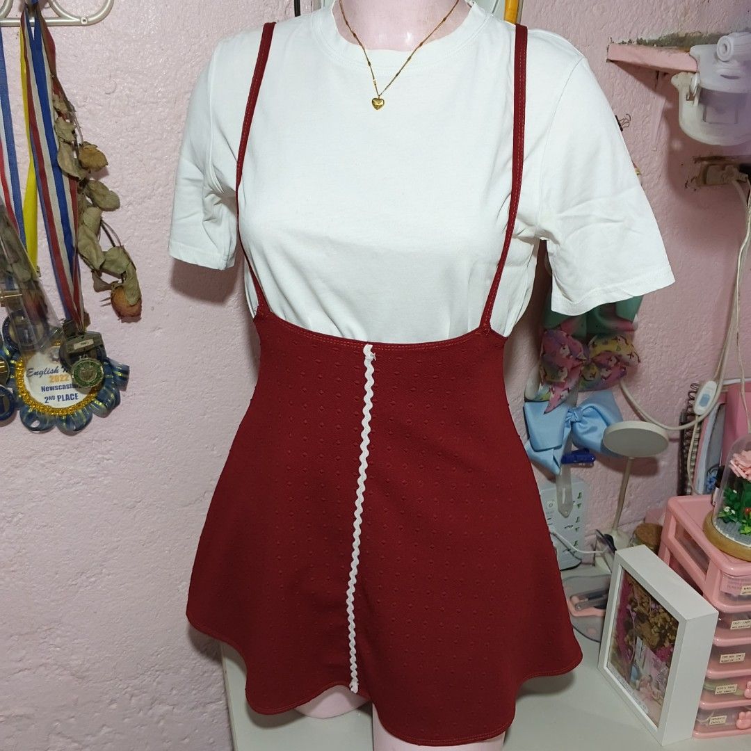 Red Suspender Dress with White Trim (Category: Dresses) located in Quezon City. Submitted by ysaai (Listing ID 1444688318, Image 1). Description: - note: Shirt not included, for photos only - Adorable red suspender dress - Textured fabric with a subtle dot pattern - Features white zigzag trim down the front - Straps cross elegantly at the back - Perfect for layering over a white tee for a fun, casual look - Easy to wear and style ‎📍 Location: Qu
