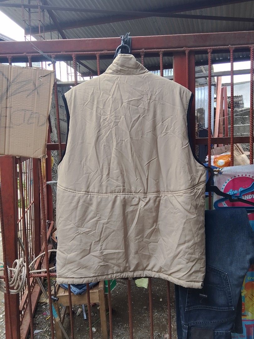 Reversible Puffer Vest - Beige and Brown (Category: Vests) located in Davao. Submitted by lentoythrift (Listing ID 1444810381, Image 2). Description: Two-in-one vest. Wear it beige or brown. Has a zipper closure and two zip pockets on the beige side. Sleeveless design, great for layering. Good for cooler weather. Check photos for details..