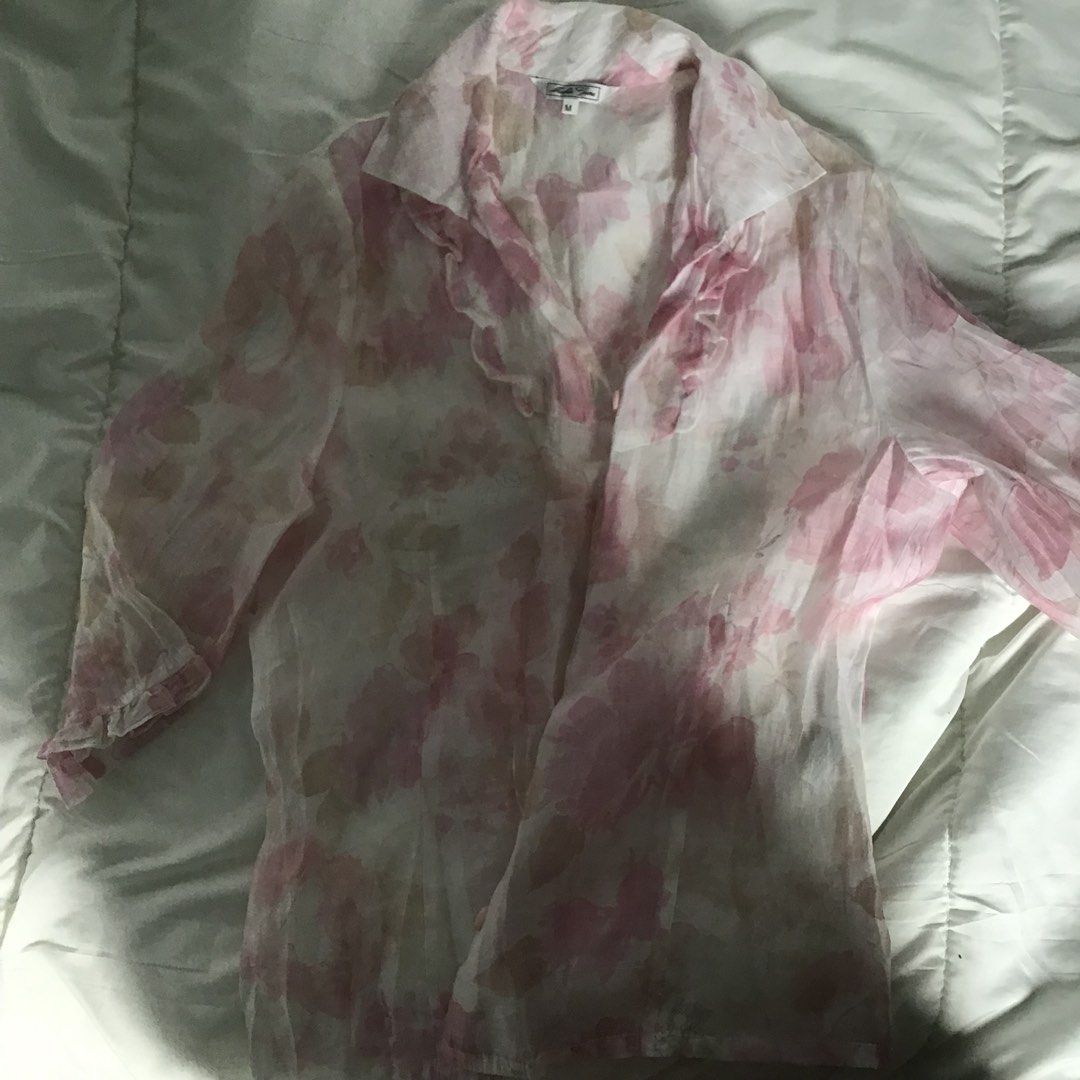 Sheer Floral Print Blouse with Ruffles (Category: Blouses) located in Itogon. Submitted by m_xary (Listing ID 1444741571, Image 2). Description: - Lightweight sheer blouse - Pink and white floral print - Delicate ruffles on collar and front - Three-quarter sleeves - Ideal for layering over camisole/tank top - Perfect for a breezy day out 🎀sf must be shouldered by the buyer 🎀MOP: Gcash.