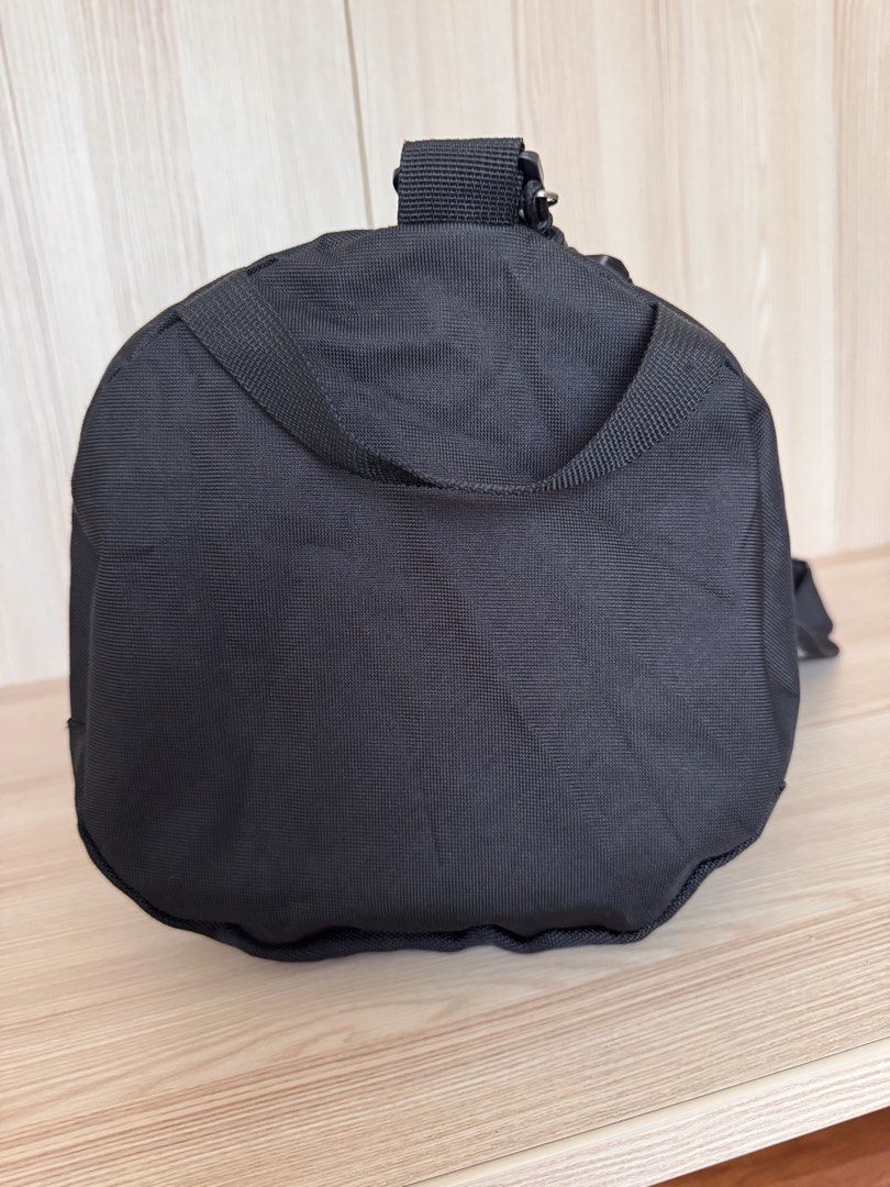 Steve Madden Black Duffel Bag with Shoulder Strap (Category: Shoulder Bags) located in Quezon City. Submitted by katharus (Listing ID 1444748188, Image 3). Description: - Stylish black duffel bag - Ideal for gym sessions or weekend getaways - Convenient front zippered pocket - Large main compartment for all your essentials - Includes a detachable shoulder strap for easy carrying - Dimensions: Approximately 20 inches long and 9 inches in diameter 