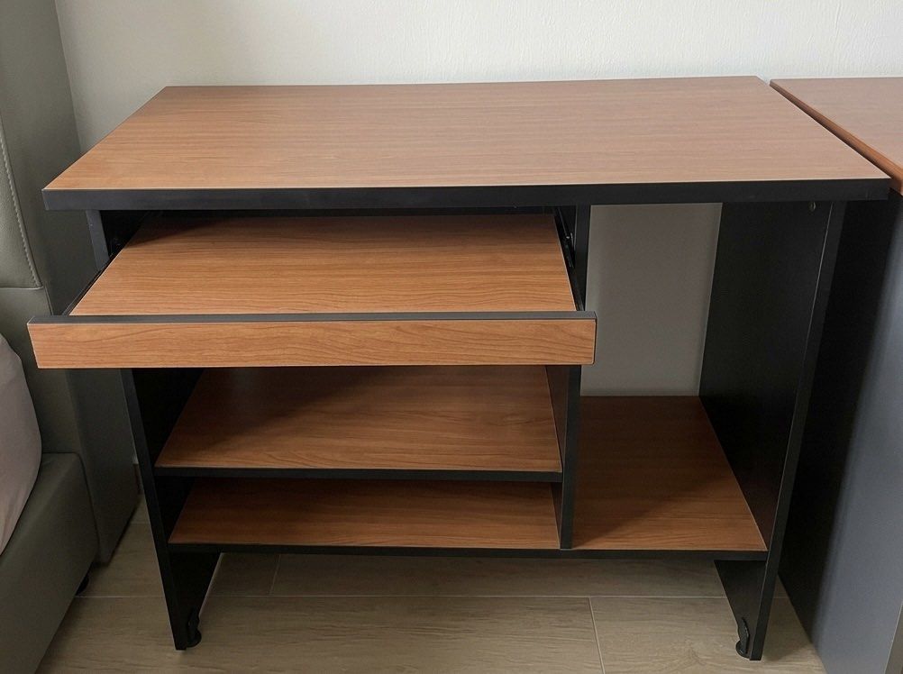 Study table and computer table set (Category: Tables & Sets) located in Singapore. Submitted by ling765 (Listing ID 1444768620, Image 2). Description: - Compact desk design, ideal for small spaces - Features a wooden top and integrated shelves for storage - Includes a convenient pull-out keyboard tray - study table $50 ( first picture) - computer table $ 38 ( second picture) .