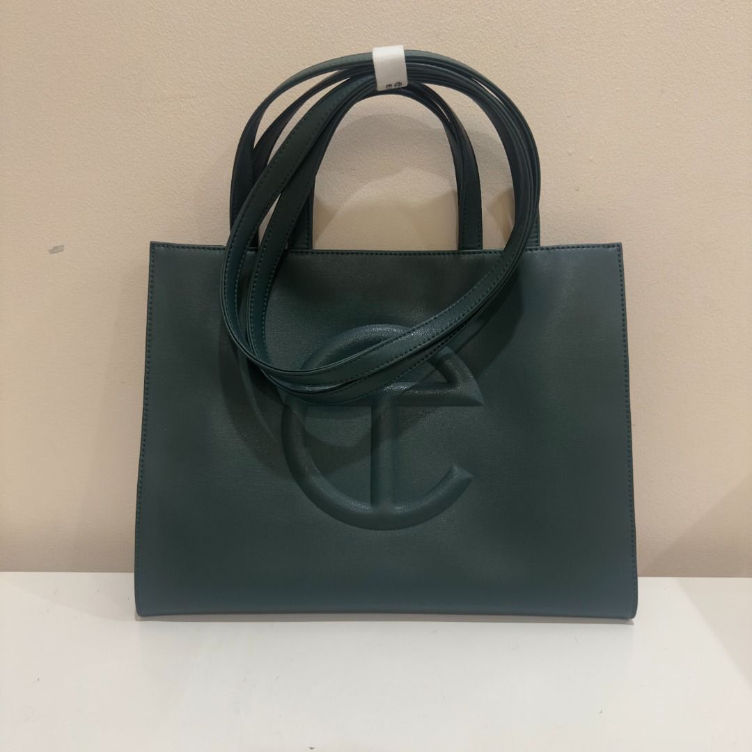 Telfar Medium Shopping Bag Dark Olive (Category: Luxury Bags & Wallets) located in Manila. Submitted by jmacg (Listing ID 1444780151, Image 1). Description: • Includes original packaging, dustbag, Telfar-branded velcro • Used only 5x • Est. Dimensions Height 11 1/4" Width 15" Depth 5" Strap Drop 21" Handle Drop 5 1/2" • Material: 50% Polyurethane, 50% Polyester • Shipping ℅ buyer.