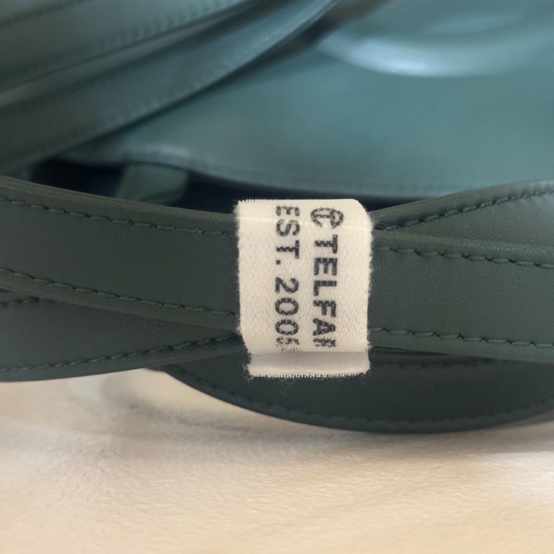 Telfar Medium Shopping Bag Dark Olive (Category: Luxury Bags & Wallets) located in Manila. Submitted by jmacg (Listing ID 1444780151, Image 3). Description: • Includes original packaging, dustbag, Telfar-branded velcro • Used only 5x • Est. Dimensions Height 11 1/4" Width 15" Depth 5" Strap Drop 21" Handle Drop 5 1/2" • Material: 50% Polyurethane, 50% Polyester • Shipping ℅ buyer.