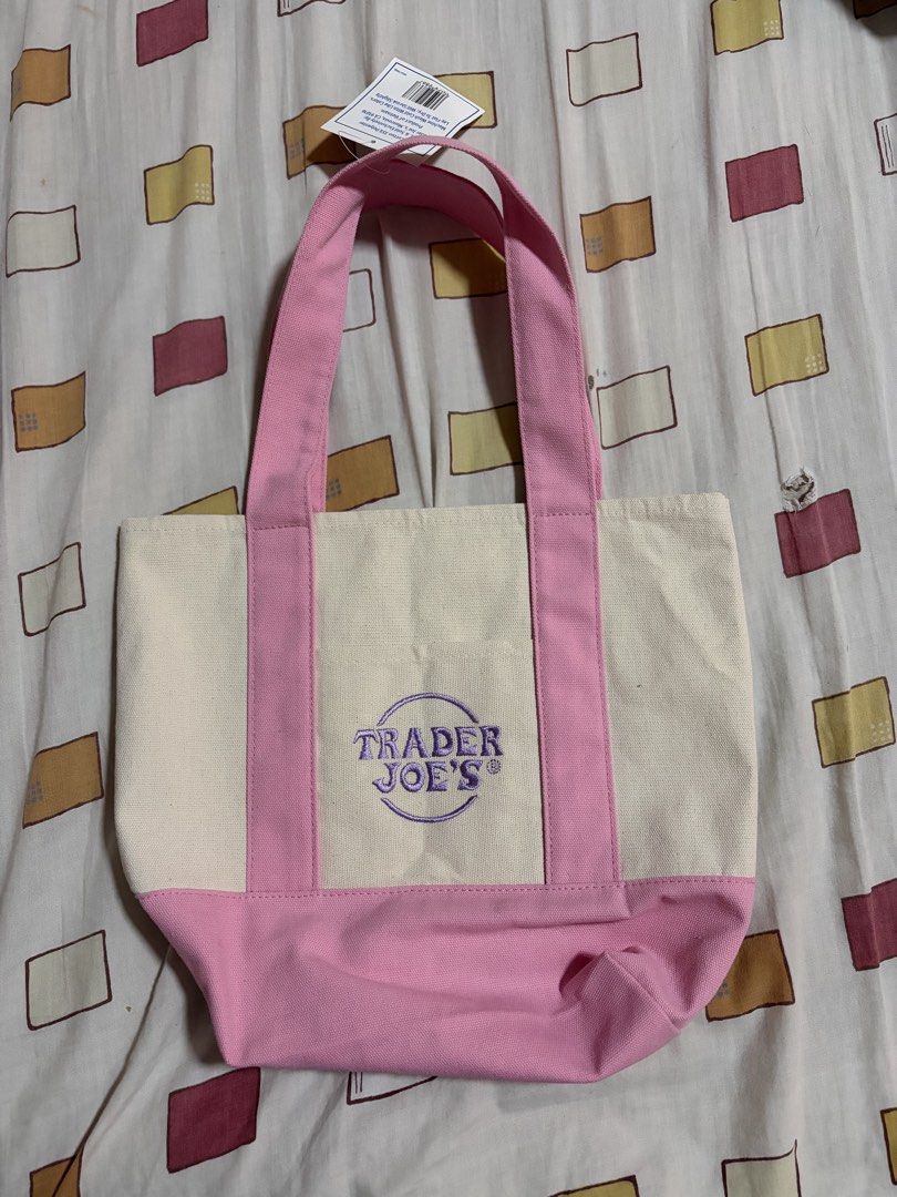 Trader Joe's Mini Pastel Canvas Tote Bag (Category: Tote Bags) located in Bulacan. Submitted by elehktrax (Listing ID 1444796794, Image 1). Description: - Cute mini tote bag from Trader Joe's - Pastel pink and cream canvas - Classic Trader Joe's logo embroidered on front - Ideal for small groceries or everyday essentials - Material: 65% Cotton, 35% Polyester - Product of Vietnam.