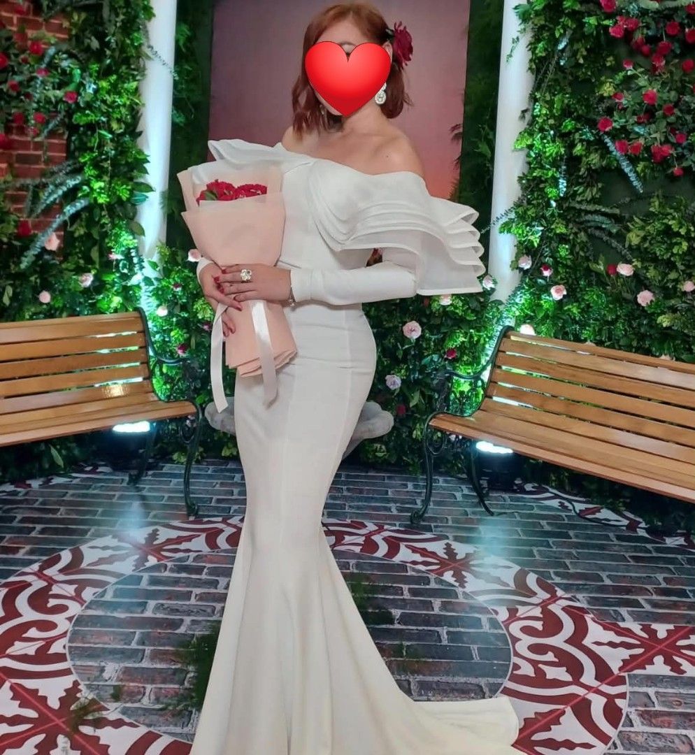White Off-Shoulder Ruffle Mermaid Gown (Category: Evening dresses & gowns) located in Paranaque City. Submitted by yanyannriley (Listing ID 1444793571, Image 1). Description: - Elegant white mermaid gown - Dramatic off-shoulder ruffle detail - Long sleeves - Floor-length with a train - Fitted silhouette - Ideal for formal events or photoshoots - Worn only once, still in amazing condition -used once.
