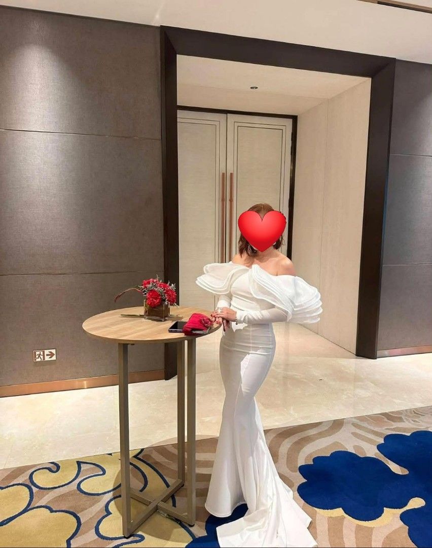 White Off-Shoulder Ruffle Mermaid Gown (Category: Evening dresses & gowns) located in Paranaque City. Submitted by yanyannriley (Listing ID 1444793571, Image 3). Description: - Elegant white mermaid gown - Dramatic off-shoulder ruffle detail - Long sleeves - Floor-length with a train - Fitted silhouette - Ideal for formal events or photoshoots - Worn only once, still in amazing condition -used once.
