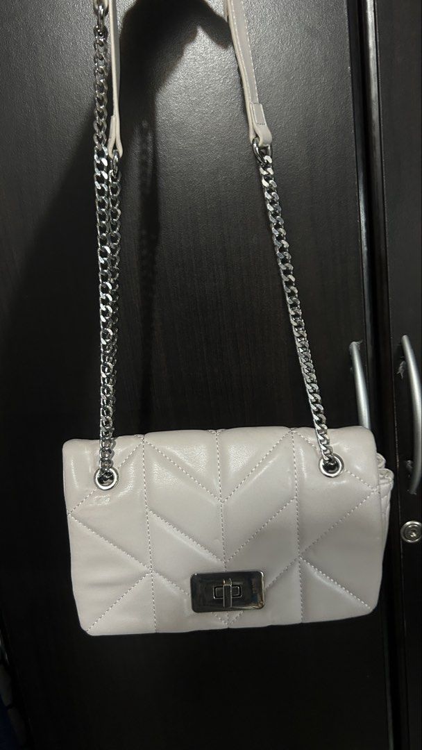 White Quilted Chain Bag with Silver Clasp (Category: Luxury Bags & Wallets) located in Manila. Submitted by kyvsphy (Listing ID 1444756454, Image 1). Description: - White quilted handbag with elegant chevron pattern - Secure silver turn-lock closure - Stylish silver chain strap - Versatile for nights out or casual wear.
