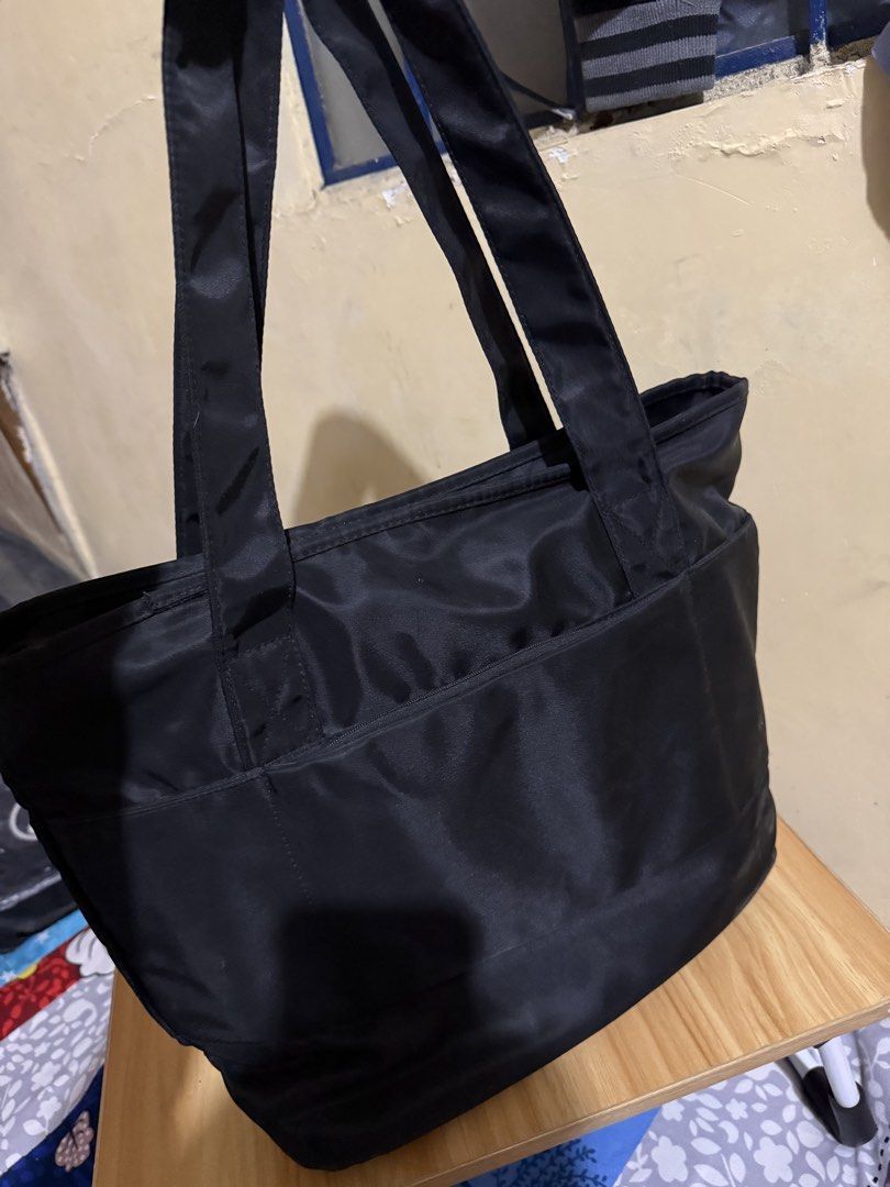World Balance Black Nylon Tote Bag (Category: Tote Bags) located in Caloocan City. Submitted by chnnnnns (Listing ID 1444828280, Image 2). Description: - Stylish black nylon tote bag - Features a cute purple balloon dog charm - Convenient zippered front pocket - Spacious main compartment with internal pockets - Ideal for everyday use or travel - Ample space for all your essentials.