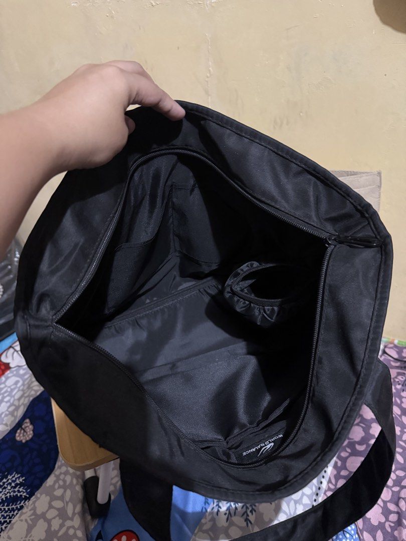World Balance Black Nylon Tote Bag (Category: Tote Bags) located in Caloocan City. Submitted by chnnnnns (Listing ID 1444828280, Image 3). Description: - Stylish black nylon tote bag - Features a cute purple balloon dog charm - Convenient zippered front pocket - Spacious main compartment with internal pockets - Ideal for everyday use or travel - Ample space for all your essentials.
