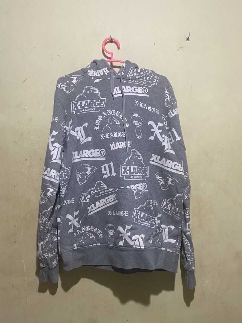 X-Large All Over Print Hoodie (Category: Hoodies) located in Manila. Submitted by bapekiddos (Listing ID 1444811844, Image 1). Description: - Grey X-Large hoodie - All-over repeating print featuring X-Large logo, gorilla graphic, and 'Los Angeles' text - Long sleeves with ribbed cuffs - Front kangaroo pocket - Comfortable and stylish streetwear piece.